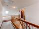 Upstairs landing featuring wood railing and view of entry and staircase at 495 Bexley St, Highlands Ranch, CO 80126