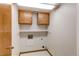 Laundry room featuring upper cabinets, shelf, and utility connections, freshly painted at 495 Bexley St, Highlands Ranch, CO 80126
