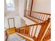 Staircase featuring wood railing and plush carpeting leading to the front entry of home at 495 Bexley St, Highlands Ranch, CO 80126