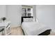 Minimalist bedroom with a bed, white walls, a large window, and a workspace, maximizing space and light at 12768 Ironstone Way # 204, Parker, CO 80134