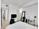 Cozy bedroom with neutral tones, a large mirror, and a dedicated workspace area at 12768 Ironstone Way # 204, Parker, CO 80134