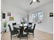 Bright dining room with stylish table, modern art, and sliding glass door to balcony with natural light at 12768 Ironstone Way # 204, Parker, CO 80134
