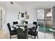 Chic dining room with seating for six, stylish chairs, and sliding glass doors to outdoor patio area at 12768 Ironstone Way # 204, Parker, CO 80134