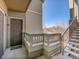 Exterior view featuring a door, a staircase, and a balcony with pleasant surroundings at 12768 Ironstone Way # 204, Parker, CO 80134
