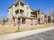 Attractive multi-story exterior with brick accents, balconies, and accessible parking at 12768 Ironstone Way # 204, Parker, CO 80134
