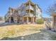 Attractive three-story condo building with brick accents and charming covered patios on a well-maintained lawn at 12768 Ironstone Way # 204, Parker, CO 80134