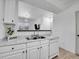 Kitchen view showcasing stainless steel sink and marble countertops with an open view to the living room at 12768 Ironstone Way # 204, Parker, CO 80134