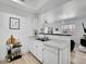 Open kitchen view with marble counters and stainless sink, flowing into the adjacent living space, perfect for entertaining at 12768 Ironstone Way # 204, Parker, CO 80134
