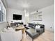 Comfortable living area showcasing a sectional sofa, modern decor, and seamless flow to the kitchen area at 12768 Ironstone Way # 204, Parker, CO 80134