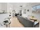 Inviting living room boasts a black leather sofa, modern lighting, and an open layout connecting to dining area at 12768 Ironstone Way # 204, Parker, CO 80134