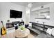 Stylish living room offers a mounted TV, decorative elements, and an open layout with views into the kitchen at 12768 Ironstone Way # 204, Parker, CO 80134