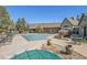 Community pool area surrounded by mature trees and comfortable outdoor seating at 12768 Ironstone Way # 204, Parker, CO 80134