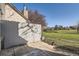 Private back patio with a wood fence, pavers, and expansive grassy common area at 2122 S Victor St # F, Aurora, CO 80014
