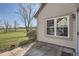 Back patio with pavers overlooking a lush lawn with mature trees and golf course at 2122 S Victor St # F, Aurora, CO 80014