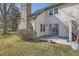 Exterior view of backyard patio with grass, mature trees and tasteful landscaping at 2122 S Victor St # F, Aurora, CO 80014