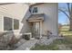 Townhouse entrance with dormer window, leading to the front door, surrounded by neat landscaping at 2122 S Victor St # F, Aurora, CO 80014
