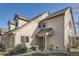 Beige townhouse exterior with covered front entrance and well-kept landscaping features at 2122 S Victor St # F, Aurora, CO 80014