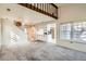 Spacious living area featuring carpeted floors, stairs, kitchen and plenty of natural light at 2122 S Victor St # F, Aurora, CO 80014