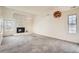 Spacious living room with a brick fireplace, built-in shelves, and large windows at 2122 S Victor St # F, Aurora, CO 80014