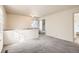 Spacious loft featuring neutral carpet, bright windows, and an open doorway at 2122 S Victor St # F, Aurora, CO 80014