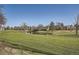 Scenic view of pond on the golf course with mature trees and landscaped grounds at 2122 S Victor St # F, Aurora, CO 80014