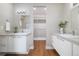 Bright bathroom features dual vanities, stylish lighting, and access to a walk-in closet at 1340 W 68Th Ave, Denver, CO 80221