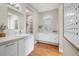 Spacious bathroom with double sinks, modern fixtures, and a walk-in closet at 1340 W 68Th Ave, Denver, CO 80221