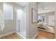 Modern bathroom featuring a glass-enclosed shower and a glimpse into the bedroom at 1340 W 68Th Ave, Denver, CO 80221