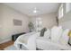 Stylized bedroom features comfortable bed, natural light, and access to bathroom at 1340 W 68Th Ave, Denver, CO 80221