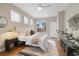 Bright bedroom featuring a large window, sleek ceiling fan, and modern decor at 1340 W 68Th Ave, Denver, CO 80221
