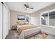 Inviting bedroom with large windows, a ceiling fan, and mountain view art offering comfort and style at 1340 W 68Th Ave, Denver, CO 80221
