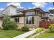 Modern home featuring a well-manicured lawn and a unique architectural design with ample natural light at 1340 W 68Th Ave, Denver, CO 80221