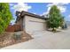 Attached two-car garage with a clean driveway and well maintained landscaping, offering convenience at 1340 W 68Th Ave, Denver, CO 80221