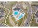 An aerial view captures the community clubhouse, pool area, playground, and parking lot at 27307 E Costilla Pl, Aurora, CO 80016