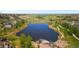 Aerial view of a lake and pond showing a surrounding community with walking trails and trees at 27307 E Costilla Pl, Aurora, CO 80016