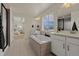 Bathroom featuring double sinks, tile flooring, soaking tub with tile surround, and separated shower at 27307 E Costilla Pl, Aurora, CO 80016