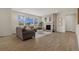 Spacious living room featuring hardwood floors, a cozy fireplace, and lots of natural light at 27307 E Costilla Pl, Aurora, CO 80016