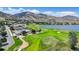 Beautiful aerial view showcases community golf course, pool, and lake, with majestic mountains as backdrop at 15789 Sandtrap Way, Morrison, CO 80465