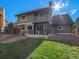 Backyard features a lawn and patio with a balcony, offering great outdoor living space at 15789 Sandtrap Way, Morrison, CO 80465