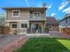 Exterior view of the house from the backyard with deck and mature landscaping at 15789 Sandtrap Way, Morrison, CO 80465