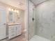 Bright bathroom featuring granite countertops, white cabinets, and a walk-in shower at 15789 Sandtrap Way, Morrison, CO 80465