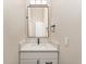 Modern bathroom featuring a vanity with white cabinets and a black faucet set against neutral walls at 15789 Sandtrap Way, Morrison, CO 80465