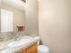 The half bathroom offers a granite counter, brushed nickel faucet, and tiled floors at 15789 Sandtrap Way, Morrison, CO 80465
