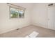Sunny bedroom with neutral walls and carpet showcases a large window providing great natural light at 15789 Sandtrap Way, Morrison, CO 80465
