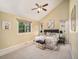 Primary bedroom featuring vaulted ceilings, soft lighting, ensuite bath, and cozy carpet at 15789 Sandtrap Way, Morrison, CO 80465