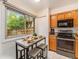Cozy breakfast nook with a window, featuring a breakfast table and modern appliances nearby at 15789 Sandtrap Way, Morrison, CO 80465