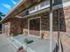Charming front entrance with stone accents, steps, and well-maintained landscaping at 15789 Sandtrap Way, Morrison, CO 80465