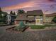 Charming two-story home featuring a unique stone facade, well-manicured lawn, and appealing landscaping at 15789 Sandtrap Way, Morrison, CO 80465