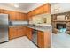 Kitchen showcases wooden cabinets, granite countertops, stainless steel appliances, and opens to the living room at 15789 Sandtrap Way, Morrison, CO 80465