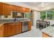 Open kitchen view with granite countertops, stainless steel appliances, and a breakfast nook at 15789 Sandtrap Way, Morrison, CO 80465